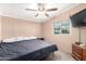 Bedroom with a ceiling fan, nightstands, and a TV at 10951 N 91St Ave # 56, Peoria, AZ 85345