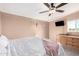 Cozy bedroom with a king-size bed and ceiling fan at 10951 N 91St Ave # 56, Peoria, AZ 85345