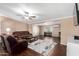 Spacious living room featuring brown leather furniture and a ceiling fan at 10951 N 91St Ave # 56, Peoria, AZ 85345