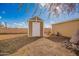 Tan colored storage shed in the backyard at 10951 N 91St Ave # 56, Peoria, AZ 85345