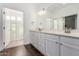 Double vanity bathroom with a large mirror and shower at 11680 E Sahuaro Dr # 2030, Scottsdale, AZ 85259