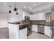 Kitchen with dark countertops and modern pendant lights at 11680 E Sahuaro Dr # 2030, Scottsdale, AZ 85259