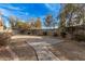 Landscaped backyard with brick paver pathway at 11921 W Port Royale Ln, El Mirage, AZ 85335