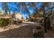 Large backyard with gravel and brick paver patio at 11921 W Port Royale Ln, El Mirage, AZ 85335