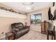 Relaxing bedroom with a comfortable recliner and large window at 11921 W Port Royale Ln, El Mirage, AZ 85335