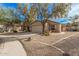 Single-story house with a two-car garage and desert landscaping at 11921 W Port Royale Ln, El Mirage, AZ 85335