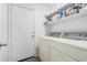 Convenient laundry room with washer, dryer, and storage at 11921 W Port Royale Ln, El Mirage, AZ 85335