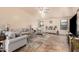 Living room featuring light gray sofas and a large TV at 11921 W Port Royale Ln, El Mirage, AZ 85335