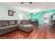 Spacious living room featuring a gray sectional sofa and dining area at 13234 N 109Th Ave, Sun City, AZ 85351