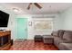 Living room with a gray sectional sofa and a view of the entryway at 13234 N 109Th Ave, Sun City, AZ 85351