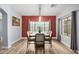 Dining area with red accent wall and hardwood floors at 13305 W Indianola Ave, Litchfield Park, AZ 85340