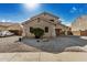 Two-story house with tan exterior, a three-car garage, and a landscaped front yard at 13305 W Indianola Ave, Litchfield Park, AZ 85340