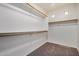 Bright walk-in closet with double hanging rods and window at 13305 W Indianola Ave, Litchfield Park, AZ 85340