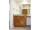 Bathroom with granite countertop, wood cabinets, and a large mirror at 14131 W Circle Ridge Dr, Sun City West, AZ 85375