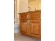 Wood vanity with granite countertop and drawers at 14131 W Circle Ridge Dr, Sun City West, AZ 85375