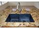 Double sink with modern faucet in granite countertop at 14131 W Circle Ridge Dr, Sun City West, AZ 85375