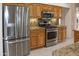 Stainless steel appliances and wood cabinets in the kitchen at 14131 W Circle Ridge Dr, Sun City West, AZ 85375