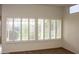 Bright living room with large windows and plantation shutters at 14131 W Circle Ridge Dr, Sun City West, AZ 85375