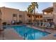 Inviting community pool with surrounding lounge chairs at 145 N 74Th St # 207, Mesa, AZ 85207