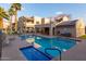 Community pool and spa with lounge chairs and covered patio area at 145 N 74Th St # 207, Mesa, AZ 85207