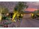 Desert landscape home with front yard and paved driveway at dusk at 16025 E Primrose Dr # B, Fountain Hills, AZ 85268