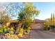 Two-car garage and desert landscaping in front of a Spanish-style home at 16025 E Primrose Dr # B, Fountain Hills, AZ 85268