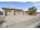 Three-car garage with driveway and landscaping; front view of house at 16036 W Sandia Park Dr, Surprise, AZ 85374