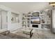 Living room with built-in shelving, fireplace, and large TV at 16036 W Sandia Park Dr, Surprise, AZ 85374