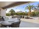 Outdoor patio with seating area and string lights; view of backyard at 16036 W Sandia Park Dr, Surprise, AZ 85374