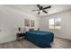 Bright bedroom with teal bedding, wood-look floors, and modern decor at 1653 N 69Th Ave, Phoenix, AZ 85035