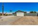 Newly painted home with a spacious driveway and desert landscaping at 1653 N 69Th Ave, Phoenix, AZ 85035