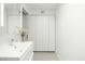 Modern bathroom with sleek white vanity and large mirrored closet at 1717 N 1St Ave # 215, Phoenix, AZ 85003