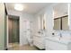 Bright bathroom featuring double vanities, modern fixtures, and a glass-enclosed shower with a neutral color palette at 1717 N 1St Ave # 215, Phoenix, AZ 85003