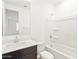 Bright bathroom showcasing a vanity, tub, and shower combination with white walls at 17457 W Eva St, Waddell, AZ 85355