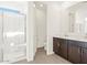 Well-lit bathroom showcasing a glass shower, dual sink vanity, and tile flooring for a contemporary feel at 17457 W Eva St, Waddell, AZ 85355