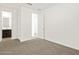 Bright, carpeted bedroom with ensuite bathroom featuring a white door at 17457 W Eva St, Waddell, AZ 85355
