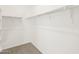 Walk-in closet with shelving and carpeted floor, providing ample storage space in a clean, white interior at 17457 W Eva St, Waddell, AZ 85355