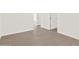 Hallway with wood-look flooring, neutral paint and access to other rooms at 17457 W Eva St, Waddell, AZ 85355