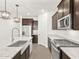 Modern kitchen with stainless steel appliances, granite countertops, and ample storage space at 17457 W Eva St, Waddell, AZ 85355