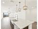 Bright kitchen features a large island with a granite countertop and stylish pendant lighting at 17457 W Eva St, Waddell, AZ 85355