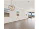 Expansive living room showcasing sleek tile flooring and ample natural light from multiple windows at 17457 W Eva St, Waddell, AZ 85355