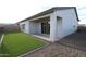Backyard featuring a covered patio, low-maintenance turf, and easy access from inside through a glass door at 19315 W Luke Ave, Litchfield Park, AZ 85340