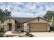 Single-story home with stone accents and a two-car garage at 19315 W Luke Ave, Litchfield Park, AZ 85340