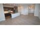 Open-concept kitchen with dark wood cabinets, granite countertops, and stainless steel appliances at 19315 W Luke Ave, Litchfield Park, AZ 85340