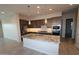 Well-appointed kitchen featuring an island with a sink, granite countertops, and modern appliances at 19315 W Luke Ave, Litchfield Park, AZ 85340