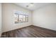 Bright bedroom with wood-look floors and plantation shutters at 2023 E Fawn Dr, Phoenix, AZ 85042