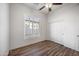 Well-lit bedroom with wood flooring and plantation shutters at 2023 E Fawn Dr, Phoenix, AZ 85042