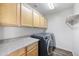 Laundry room with washer, dryer, and upper cabinets at 2023 E Fawn Dr, Phoenix, AZ 85042