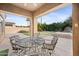 Covered patio with table and chairs, overlooking backyard at 2023 E Fawn Dr, Phoenix, AZ 85042