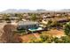 Aerial view of a house with pool, surrounded by manicured lawns and mountain views at 21086 E Mewes Rd, Queen Creek, AZ 85142